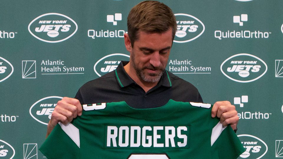 Apr 26, 2023; Florham Park, NJ, USA; New York Jets quarterback Aaron Rodgers (8) looks down at his jersey during the introductory press conference at Atlantic Health Jets Training Center. Mandatory Credit: Tom Horak-USA TODAY Sports