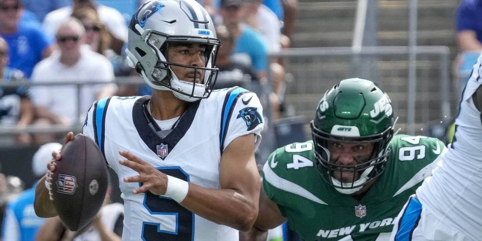 Aug 12, 2023; Charlotte, North Carolina, USA;Carolina Panthers quarterback Bryce Young (9) throws under pressure from New York Jets defensive end Solomon Thomas (94)  during the first quarter at Bank of America Stadium. Mandatory Credit: Jim Dedmon-USA TODAY Sports